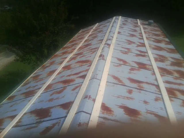 Rusted metal roof panels with new wood purlins before replacement — Storm Damage Roof Repair in Davidson by Roofing Brothers